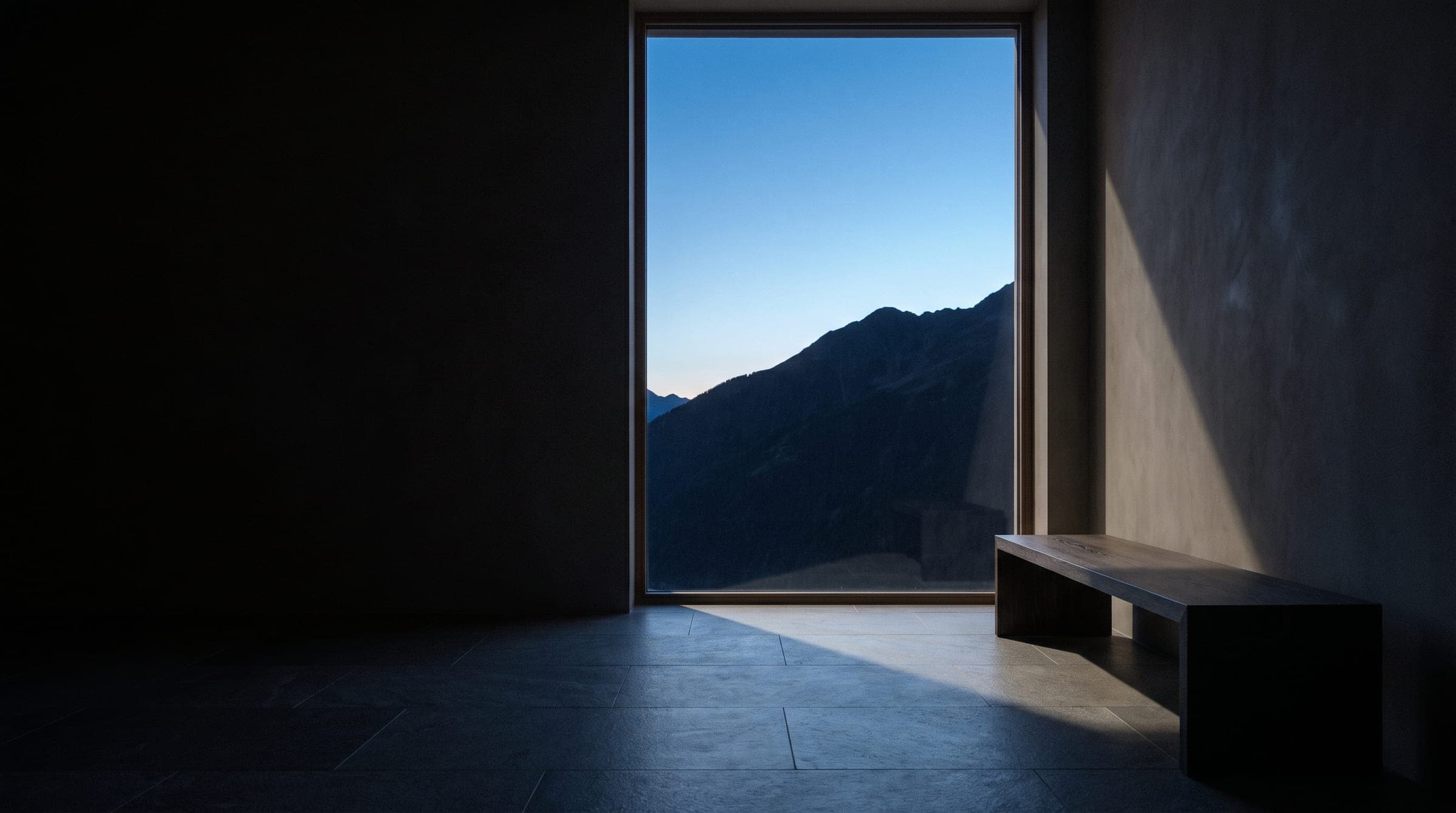 Halden House concept: minimal alpine room at blue hour with a tall window onto a mountain ridge